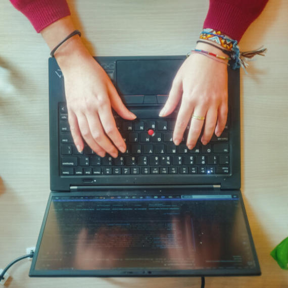 a person's hands on a laptop
