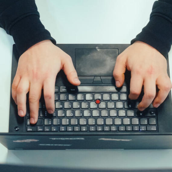 a person typing on a laptop
