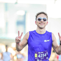 a man wearing sunglasses and a purple shirt