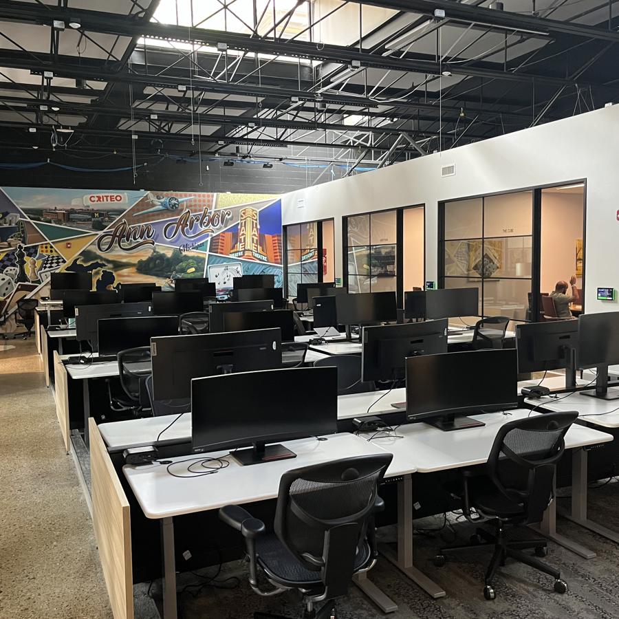 a room with computers and chairs