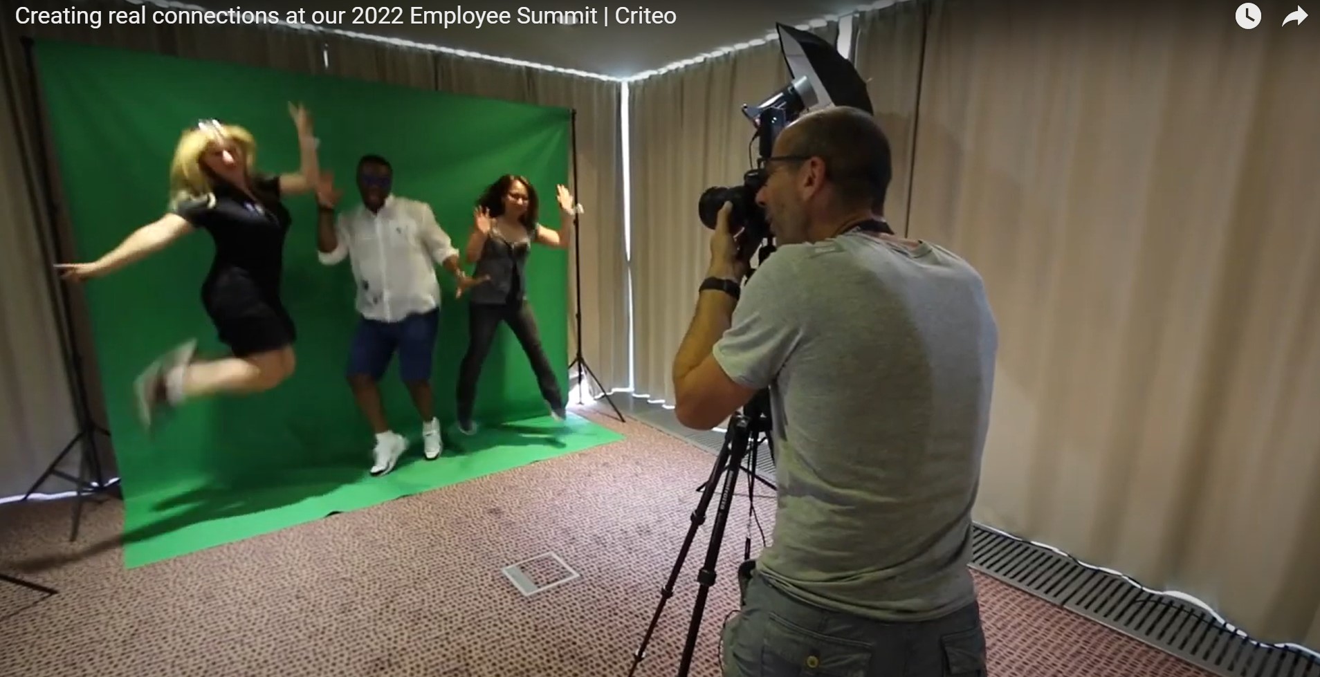 a man taking a picture of a woman and a man in a room