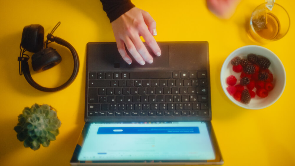 a hand on a laptop