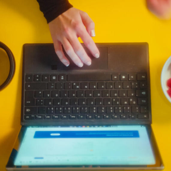 a hand on a laptop