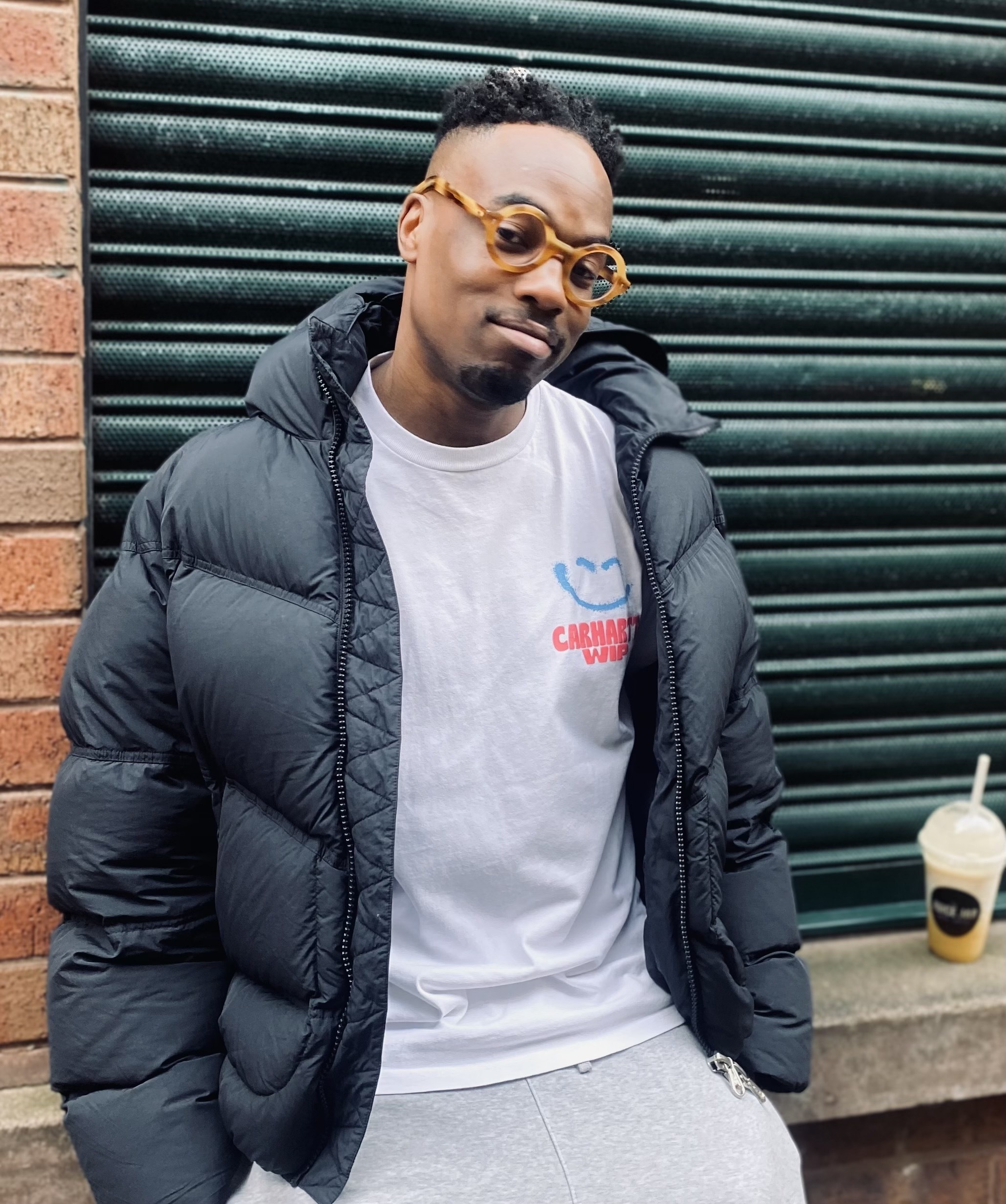 a man wearing glasses and a puffy coat