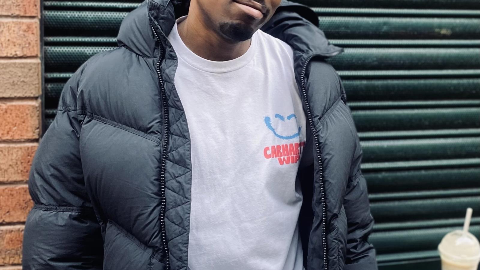 a man wearing glasses and a puffy coat