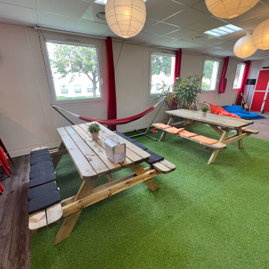 a room with a table and hammocks