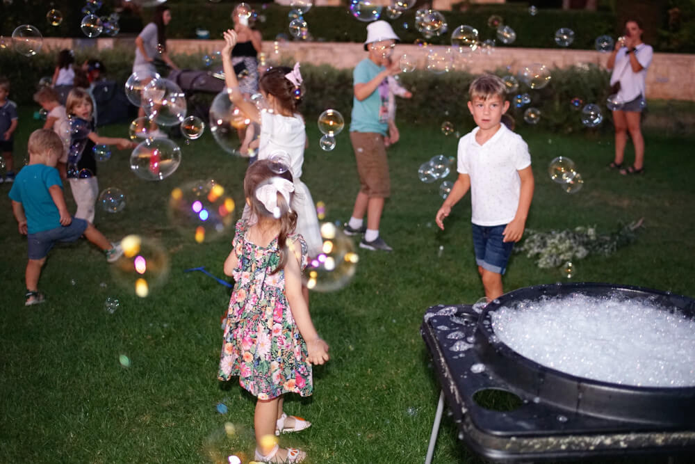a group of kids playing with bubbles
