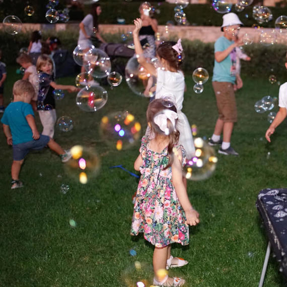 a group of kids playing with bubbles