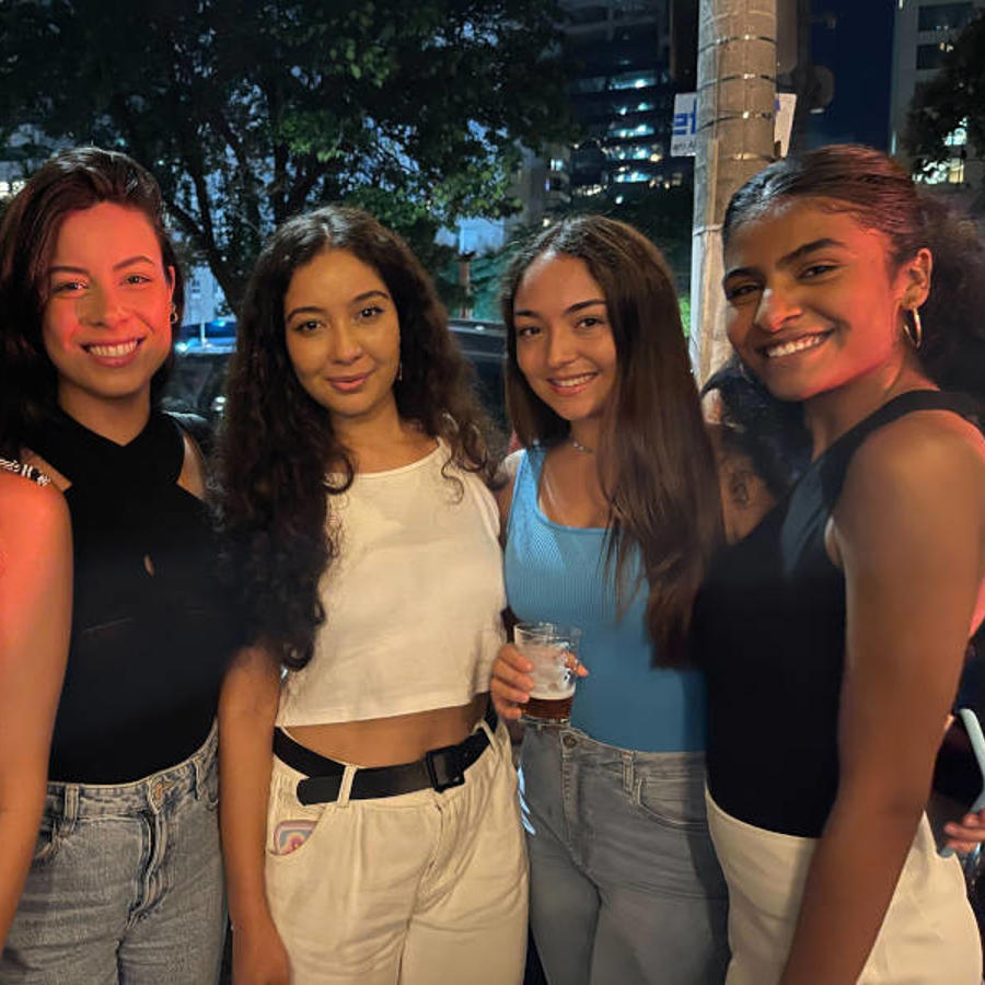 a group of women standing together smiling