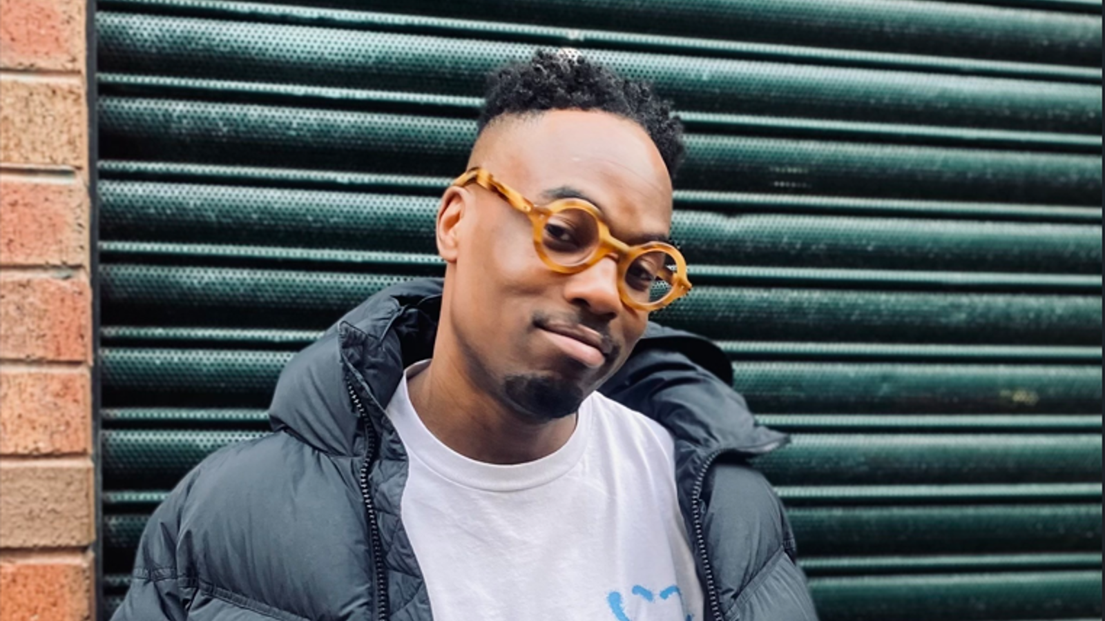 a man wearing glasses and a puffy coat