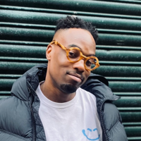 a man wearing glasses and a puffy coat