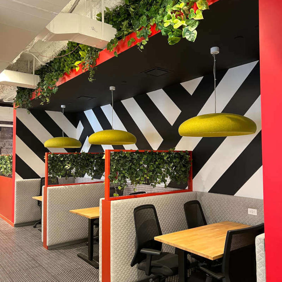 a room with black and white wall and plants