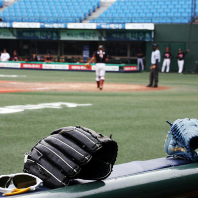 a baseball glove and gloves on a bench