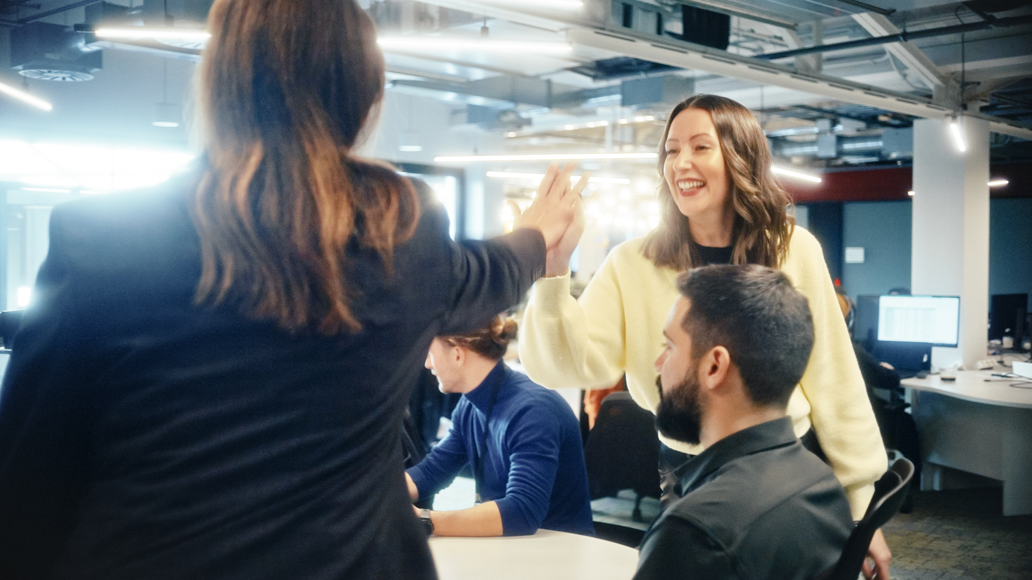 a woman giving a high five to a group of people