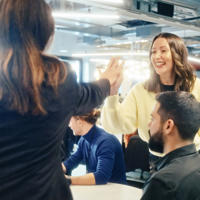 a woman giving a high five to a group of people