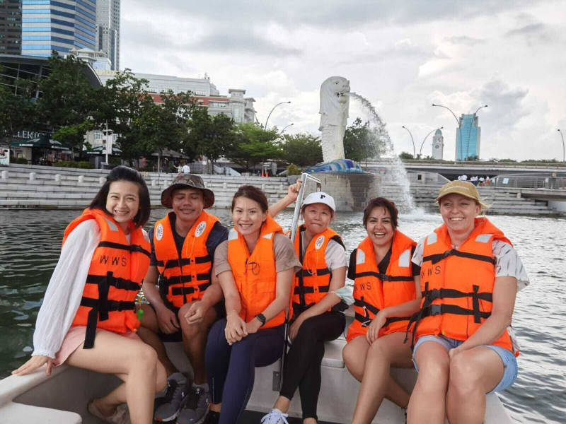 a group of people in life vests sitting on a boat