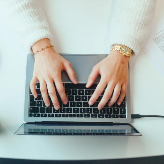 a person typing on a laptop