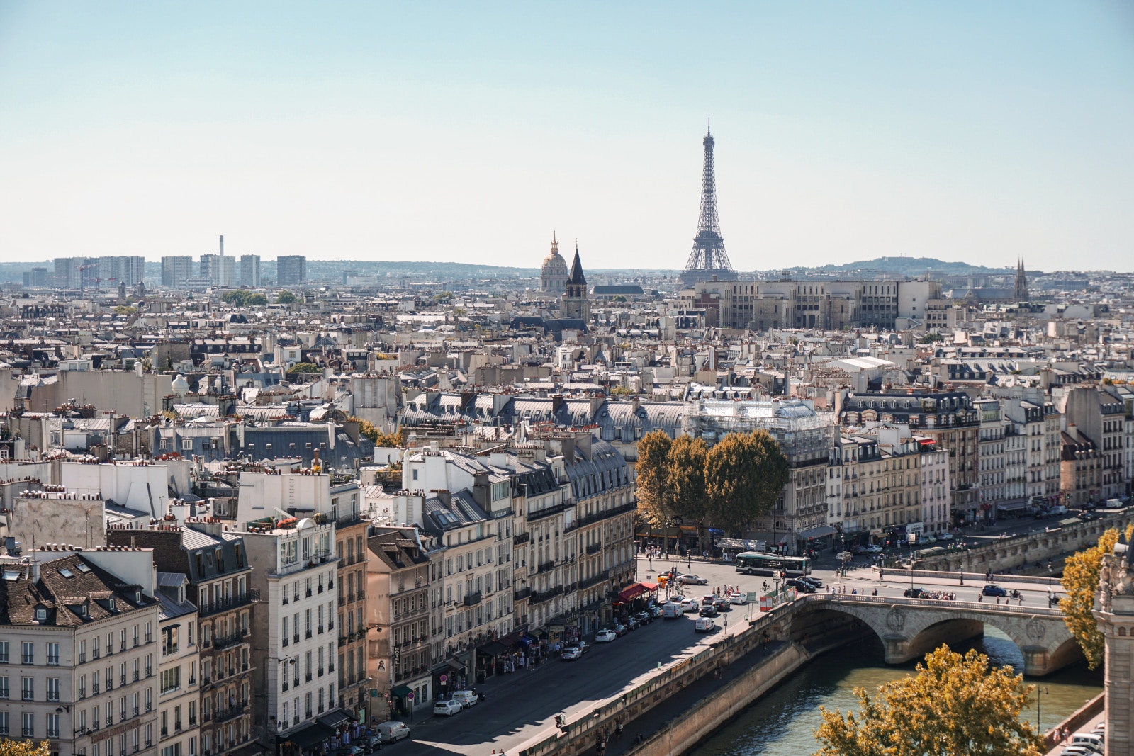 a city with a bridge and a tower in the background