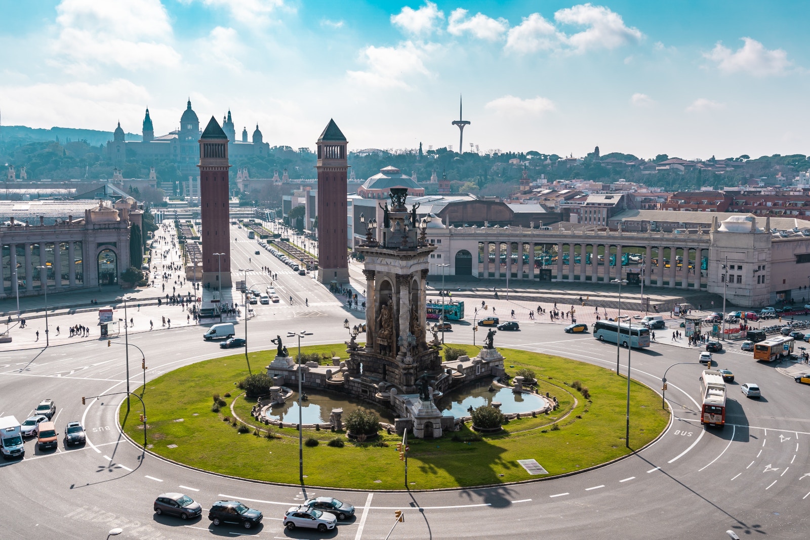 a circular road with a fountain and cars in the middle