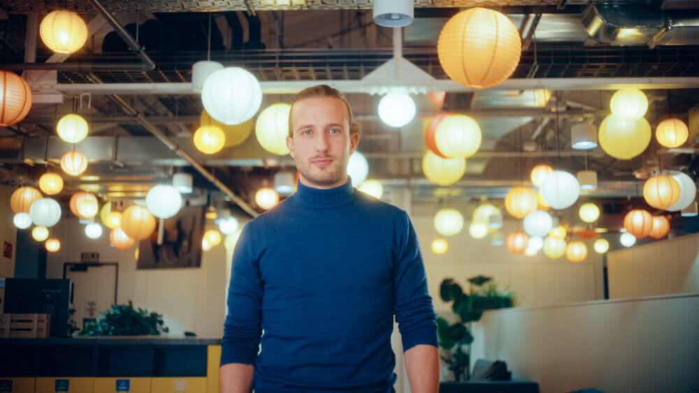 a man standing in a room with lanterns