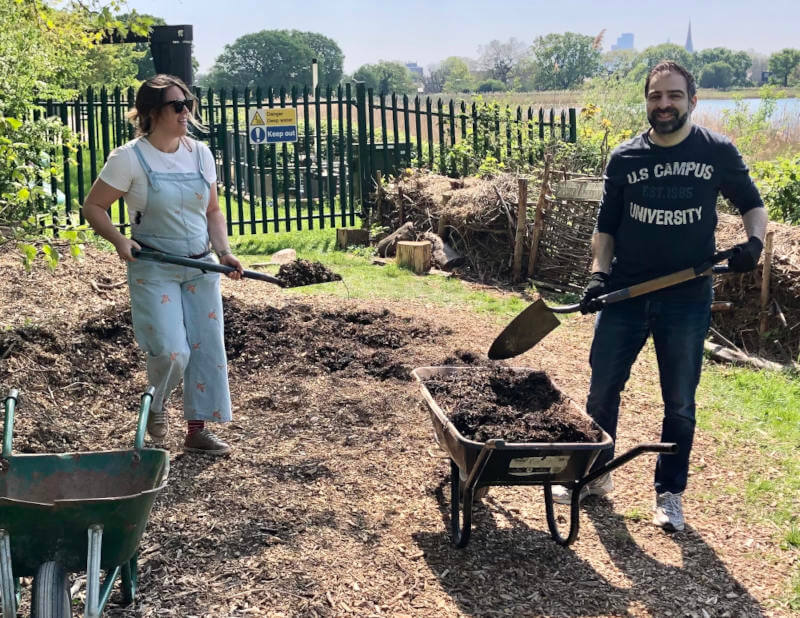 a man and woman working in a garden
