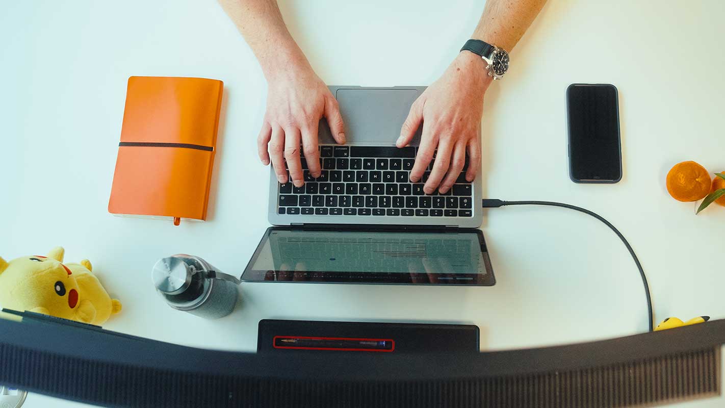 a person typing on a laptop
