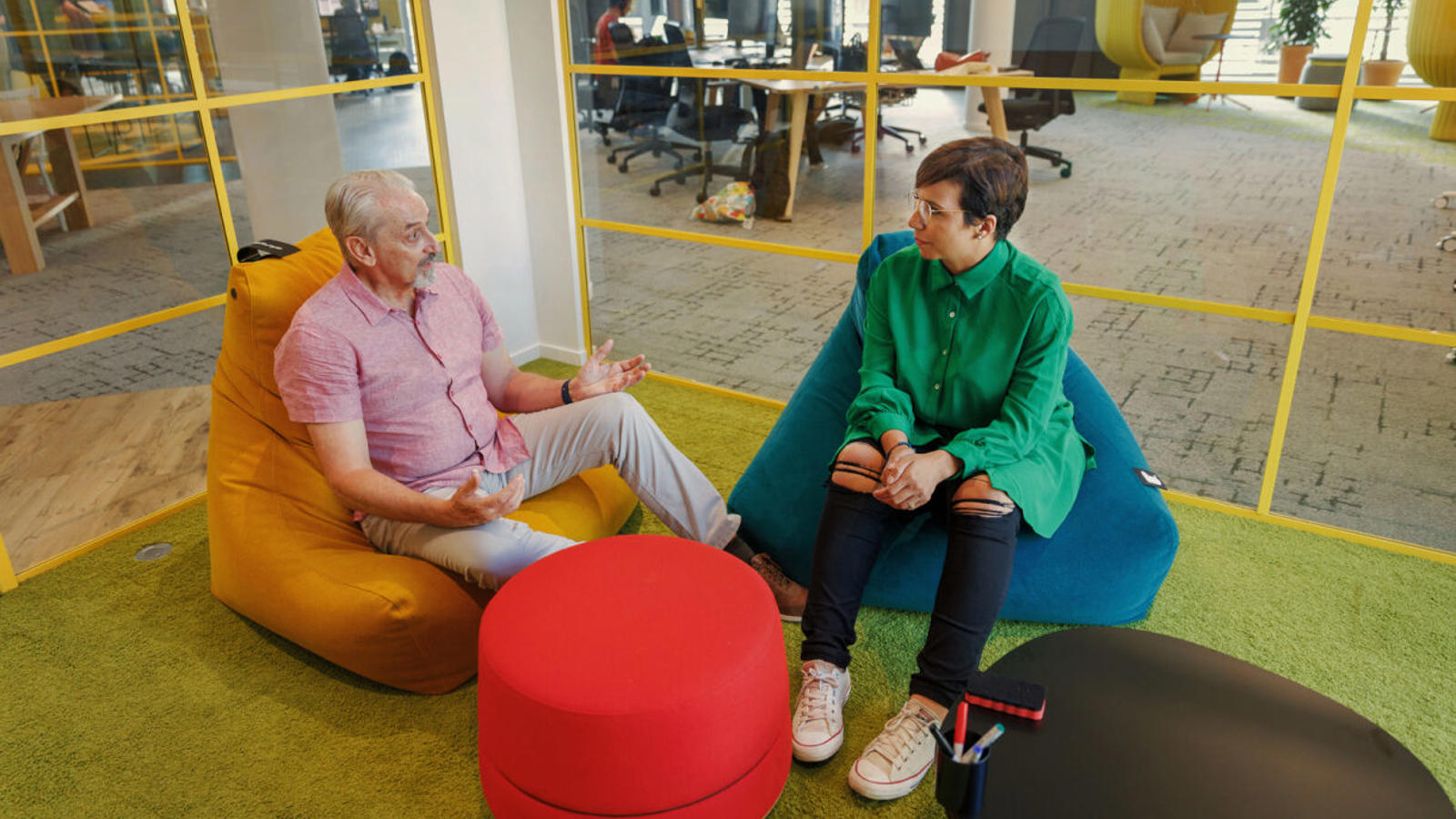 two people sitting in bean bags