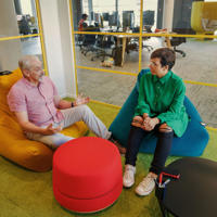 two people sitting in bean bags