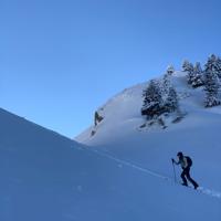 a person hiking up a snowy mountain