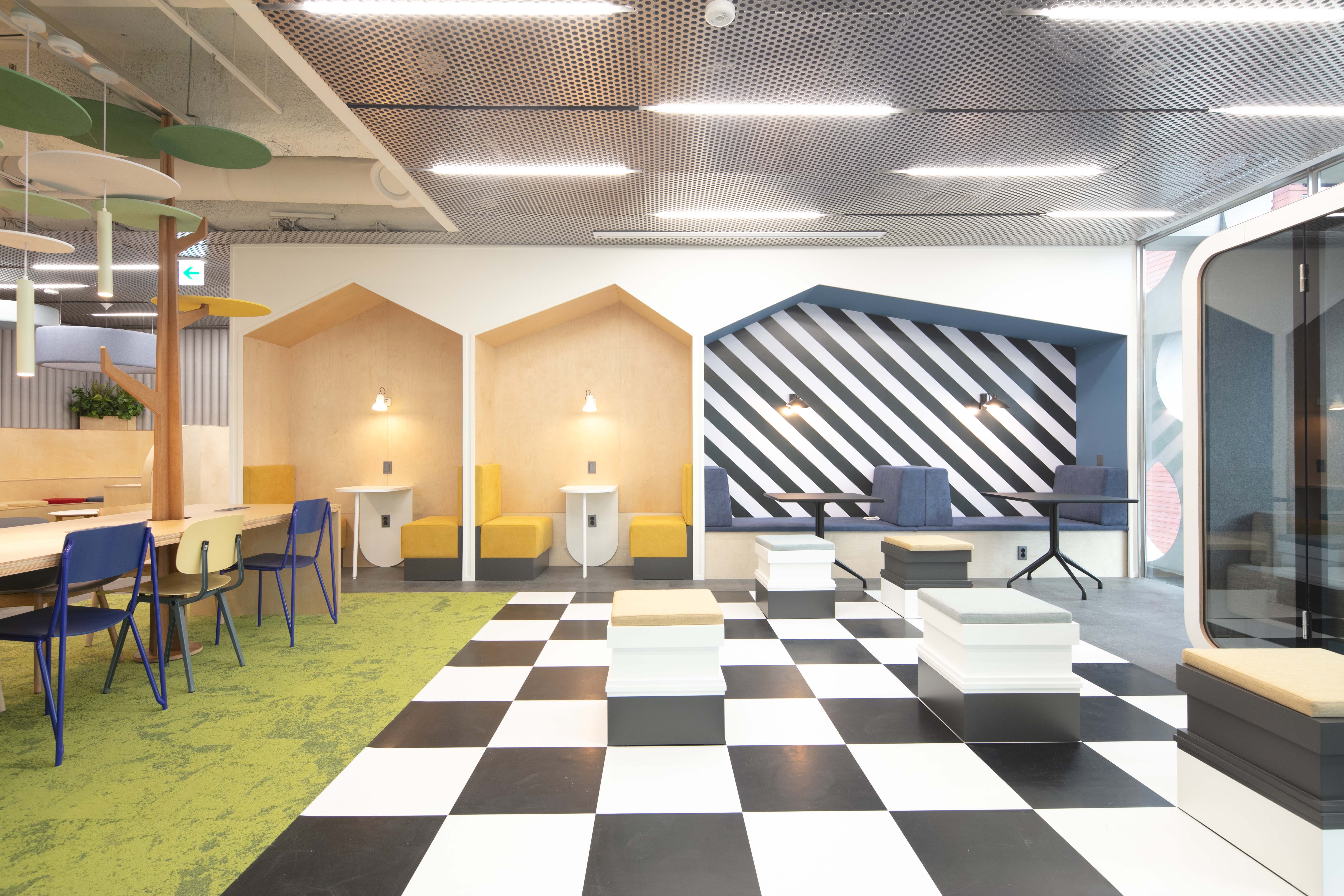 a room with black and white checkered floor and chairs