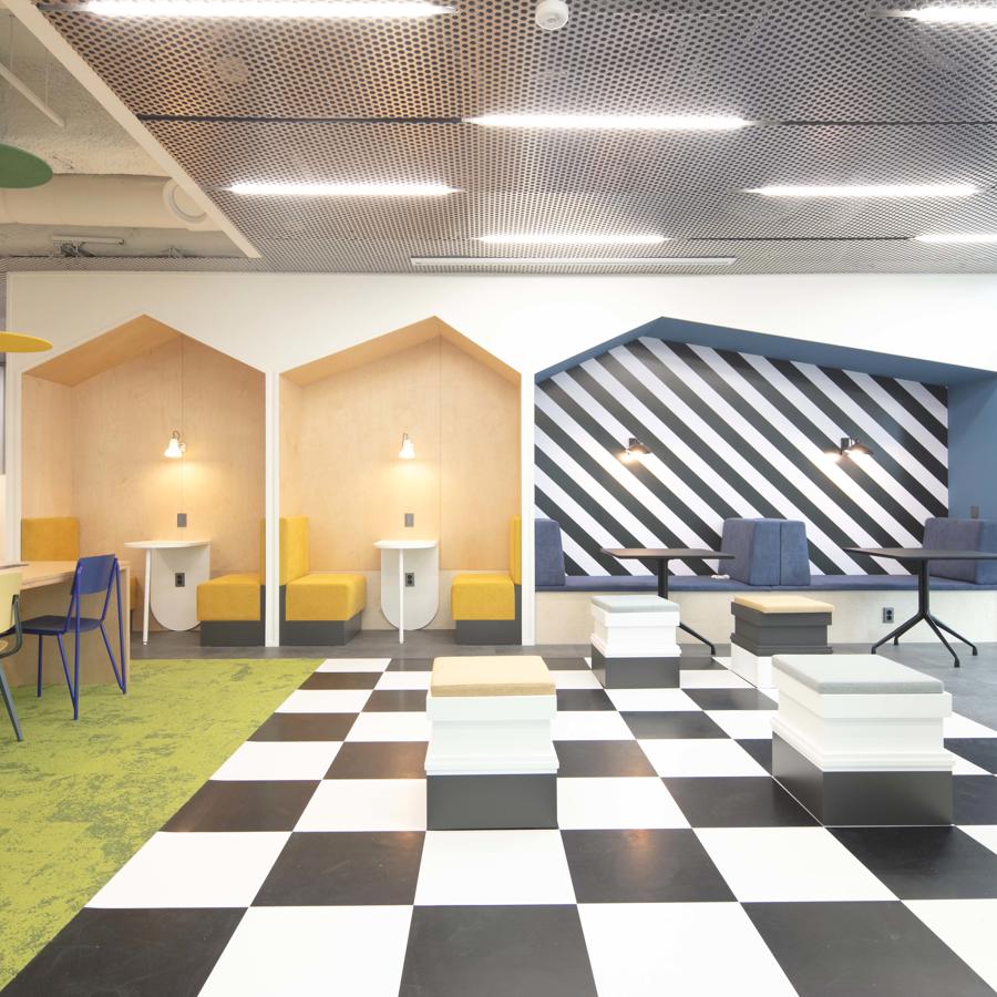 a room with black and white checkered floor and chairs